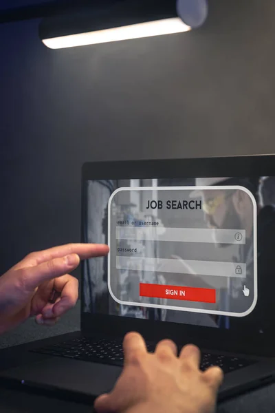 Man browsing job opportunities online using job search in computer application, unemployed man looking for new vacancies on website page on laptop screen.