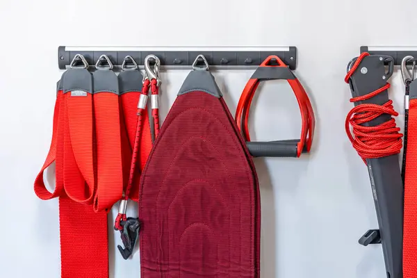 Red cord slings for therapeutic exercises and neuromuscular activation, Neurac technique.