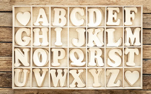 Complete english alphabet, study of English language, wooden letters and box.