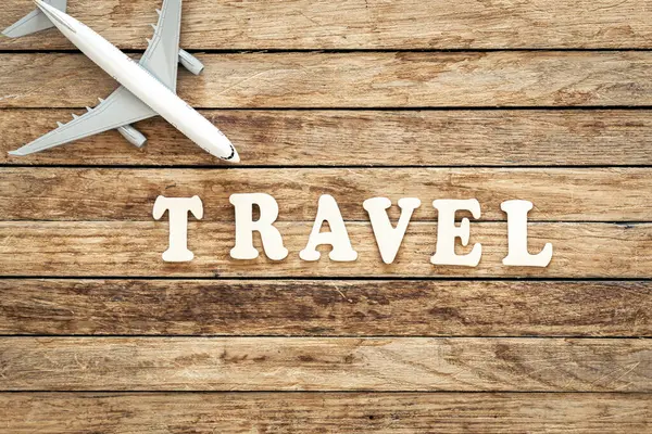 Word Travel Airplane Wooden Background Top View — Stock Photo, Image