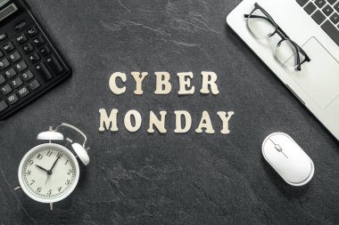 Dizüstü bilgisayar ve hesap makinesiyle desenli siyah bir arkaplan üzerine Pazartesi Cyber Pazartesi metni.