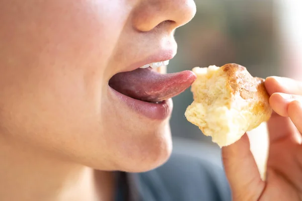 stock image Detailed shot of a woman eating a fresh bun, macro shot of eating pastry.