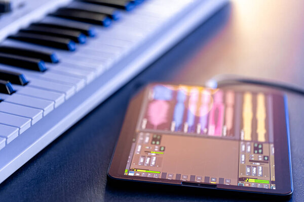 Musical keys and tablet on the table, musical application for digital tablet, music recording.