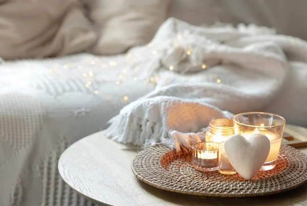 Romantic composition for Valentines Day with candles in the interior of the room. Copy space.
