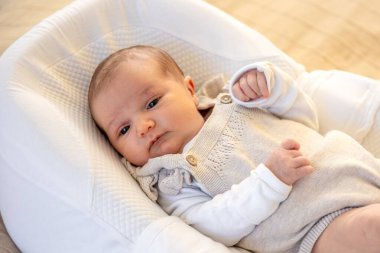 Yeni doğmuş bebek. Yeni doğmuş bebeğe yakın çekim. Yüksek kalite fotoğraf. Annelik. Yeni doğmuş bir bebek yatakta yatıyor. Evde yeni doğmuş bir bebek.