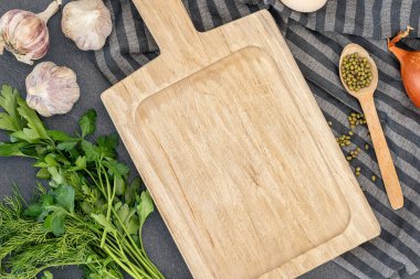 Pişirme malzemeleri ve boş bir kesim tahtası olan bir arka plan. Yemek yapmak için gerekli malzemeler. Yüksek kalite fotoğraf. Karanlık bir arka planda malzemeleri olan bir arka plan. Uzayı kopyala Üst manzara, düz uzanma.