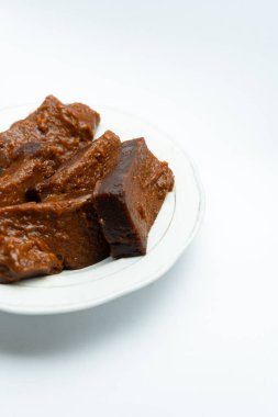 Dodol on a serving plate. This traditional sweet snack originating from Indonesia made from glutinous rice flour, coconut milk and brown sugar that are cooked for a long time, are sweet, savory and chewy. clipart