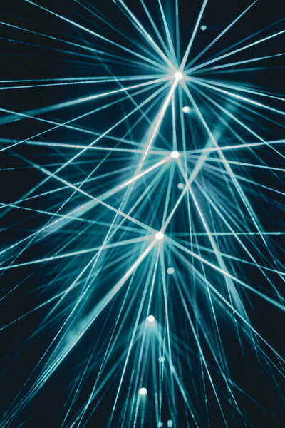 A stunning performance of blue lasers, weaving a web of light in the darkness.