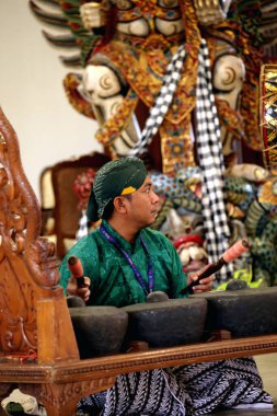 Jakarta, Indonesia. April 13, 2024. Artists play Gamelan Carabalen to welcome the arrival of tourists at the TMII tourist attraction, Jakarta. Tourists can play too. clipart