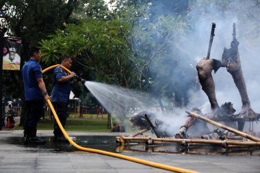 Jakarta, Endonezya. 21 Nisan 2024. İtfaiyeciler, Jakarta 'nın TMII turizm sahasında bir Ogoh-ogoh' u yutan bir yangını söndürüyor.