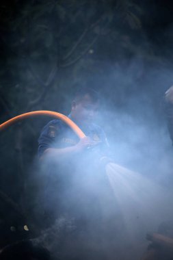 Jakarta, Endonezya. 21 Nisan 2024. İtfaiyeciler, TMII turistik merkezinde Ogoh-ogoh 'u yakan yangını söndürmek için yüksek basınçlı su püskürtüyorlar, Jakarta..