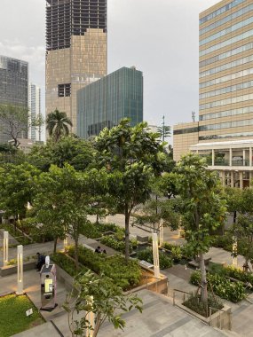 Jakarta, Indonesia - April 26, 2024: City Park of Sarinah Thamrin Building. Located on M.H. Thamrin street, Jakarta, Indonesia. It is an eco friendly park. clipart