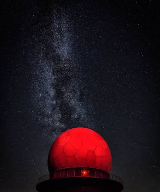 A red dome stands prominently against a backdrop of a vibrant star-filled sky. clipart
