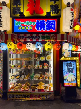 A vibrant restaurant sign and enticing food display highlight the best of Japanese cuisine under colorful lights clipart