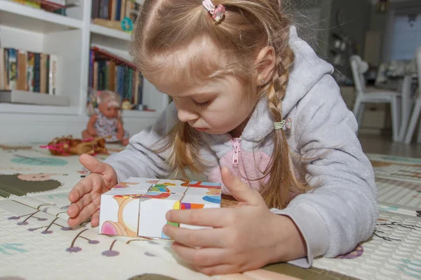 Little cute girl spending time in the playroom, soft focus background