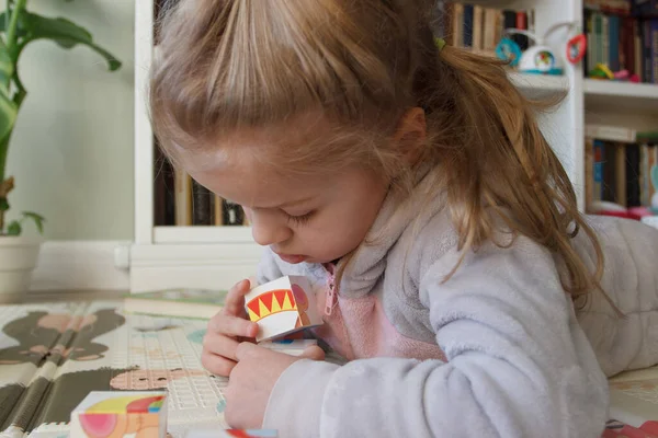 Little cute girl spending time in the playroom, soft focus background