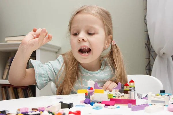 stock image Child builds with constructor bricks, plays with toys, soft focus background