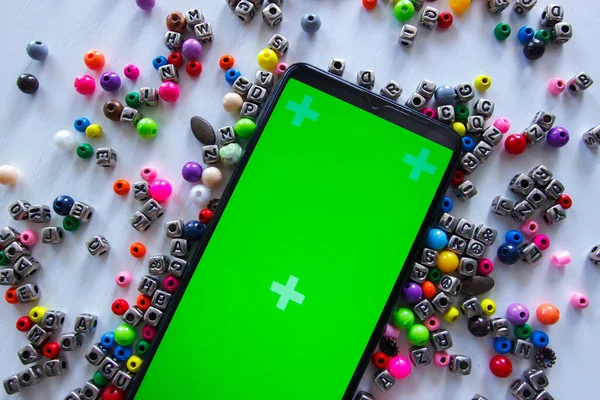 Smartphone Green Screen Different Colored Beads Numbers Symbols Top View — Stock Photo, Image