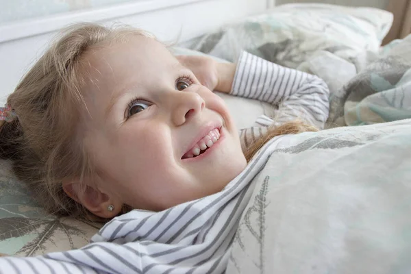 stock image Little cute girl lying in the bed. Concept of rest at home