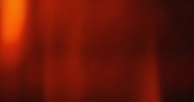 Bulanık kırmızı ve turuncu arkaplan. Yumuşak ışık ince bir doku yaratır. Sıcak renk paleti.