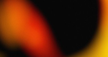 Portakal sarısı ve siyah gradyanı olan bulanık bir arkaplan. Yumuşak ışık efektleri desenli bir görünüm yaratır.