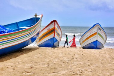 Chavakkad deniz sahilinde, Kerala Hindistan 'ın yanında renkli bir tekne duruyor.