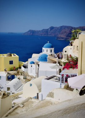 Blue Domes of Santorini Greece with whitewashed building and a view of the sea with free space and copy space no people