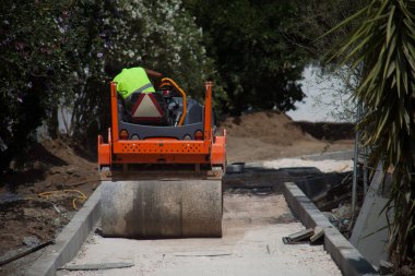 Powerful construction compactor at work, shaping the foundation with precision. Essential equipment for building projects.