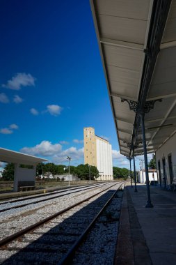 Portalegre, Portugal. May 19, 2024. A tranquil view of Portalegre Railway Station in Portugal, showcasing its charming architecture with classic white and yellow hues. clipart