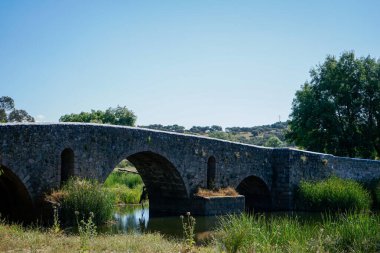 Monforte, Portugal. May 19, 2024. Ancient Roman bridge over Ribeira de Monforte, Portugal. An architectural marvel set in a serene landscape, showcasing historic stone craftsmanship.
