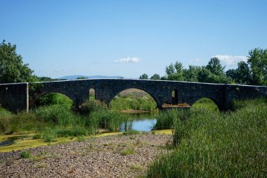 Monforte, Portugal. May 19, 2024. Ancient Roman bridge over Ribeira de Monforte, Portugal. An architectural marvel set in a serene landscape, showcasing historic stone craftsmanship.
