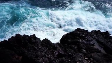 Dalgalar Terceira Adası, Azores, Portekiz 'in engebeli volkanik kayalıklarına çarparak adanın ham doğal güzelliğini ve dinamik deniz manzarasını gözler önüne seriyor..