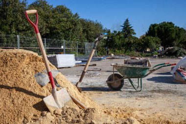 Construction site with wheelbarrows ready for work. Ideal for industrial, renovation, or building projects.