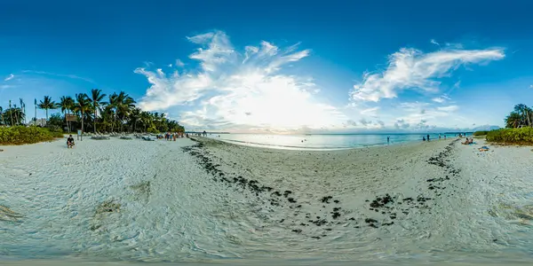 Gün batımında Trou Aux Bishes Mauritius plajında 360 derece manzara. Sahilde yürüyen bir sürü insan var..