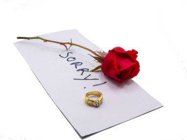 Note of apology with weeding ring and rose on wood clipart
