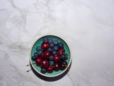 Fotokopi aletiyle mermer zemin üzerinde taze organik kirazlar