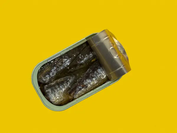 stock image A can of sardines with oil against an isolated yellow background