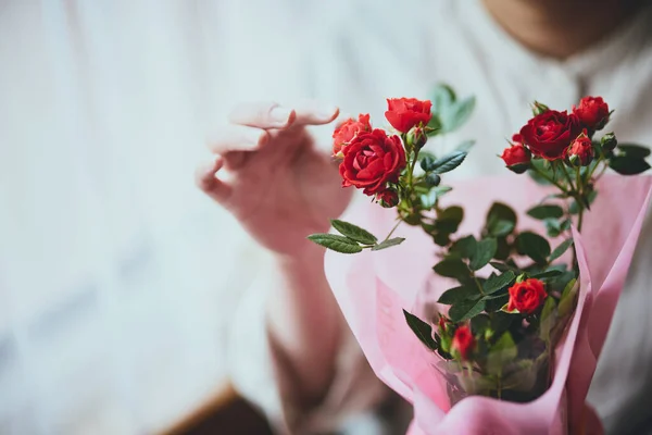 stock image Woman with carnations by the window