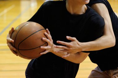 İnsanlar spor salonunda basketbol oynuyor.