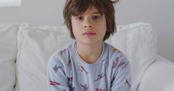 Young Boy Tousled Hair Sleepy Eyes Wears Rocket Patterned Pajamas — Stock Video