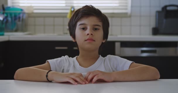 Boy Brown Hair Sits Kitchen Table His Arms Crossed Front — Stock Video