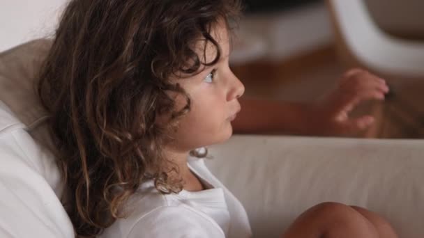 Young Boy Long Curly Hair Lounging Comfortably Couch Gazing Thoughtfully — Stock Video