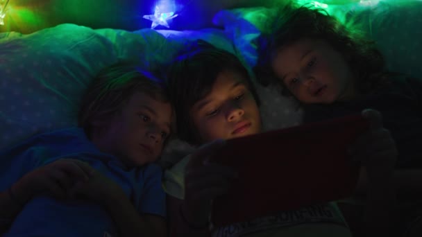 Група Дітей Лежить Ліжку Поруч Один Одним Використовує Цифровий Стіл — стокове відео