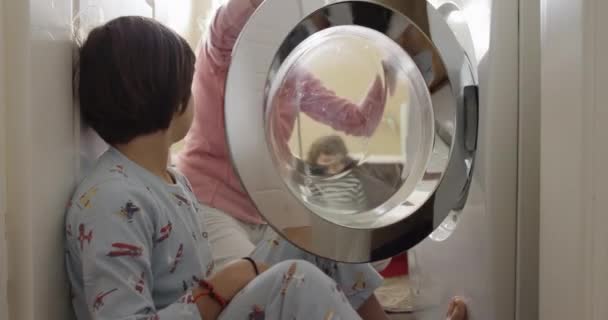 Mother Supervises Her Young Kids Dressed Pajamas Watch Clothes Spin — Stock Video