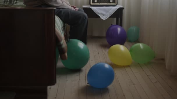Elderly Gentleman Sits Pensively Bed Radio Surrounded Vibrant Balloons Suggesting — Αρχείο Βίντεο