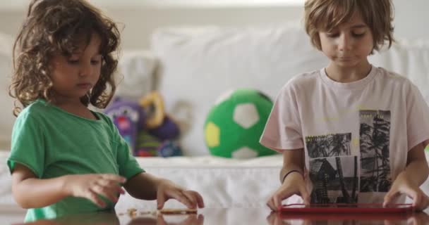 Boys Engrossed His Digital Tablet Reaches Snack Surrounded Colorful Toys — Vídeo de stock