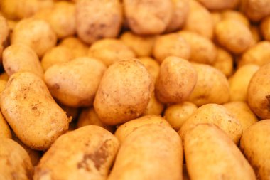 Pazar tezgahında taze patatesler, yakın plan.