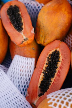 group of exotic orange papaya fruits on a stall at the bazaar clipart