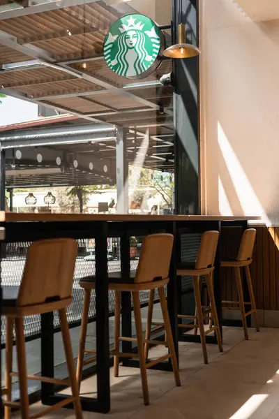 stock image Antalya, Turkey - June 28, 2024: Starbucks cafe, bar stools by the window, no people