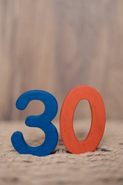 Bej rengi bulanık arka plan, tatil tarihi, yıldönümü, metin için fotokopi alanı olan jübile tebrik kartı üzerinde 30 numaralı ahşap figür.